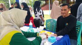 Petugas medis Dinas Kesehatan Kabupaten Pesisir Selatan memeriksa darah peserta tes kebugaran jasmani di GOR H. Ilyas Yakub Painan, Kamis (16/10/2025)